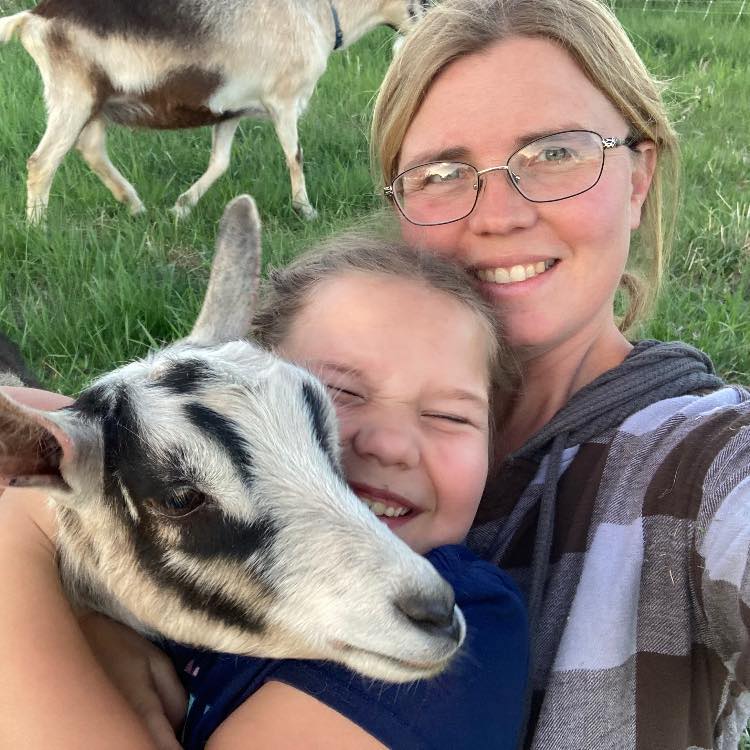Leah Matzke with a goat on the farm